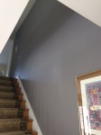 We chose a lighter warm gray for this entry and ahllway, but shifted to a deeper shade of gray - with a mysterious purple undertone for the stairway wall. Just the right amount of drama.